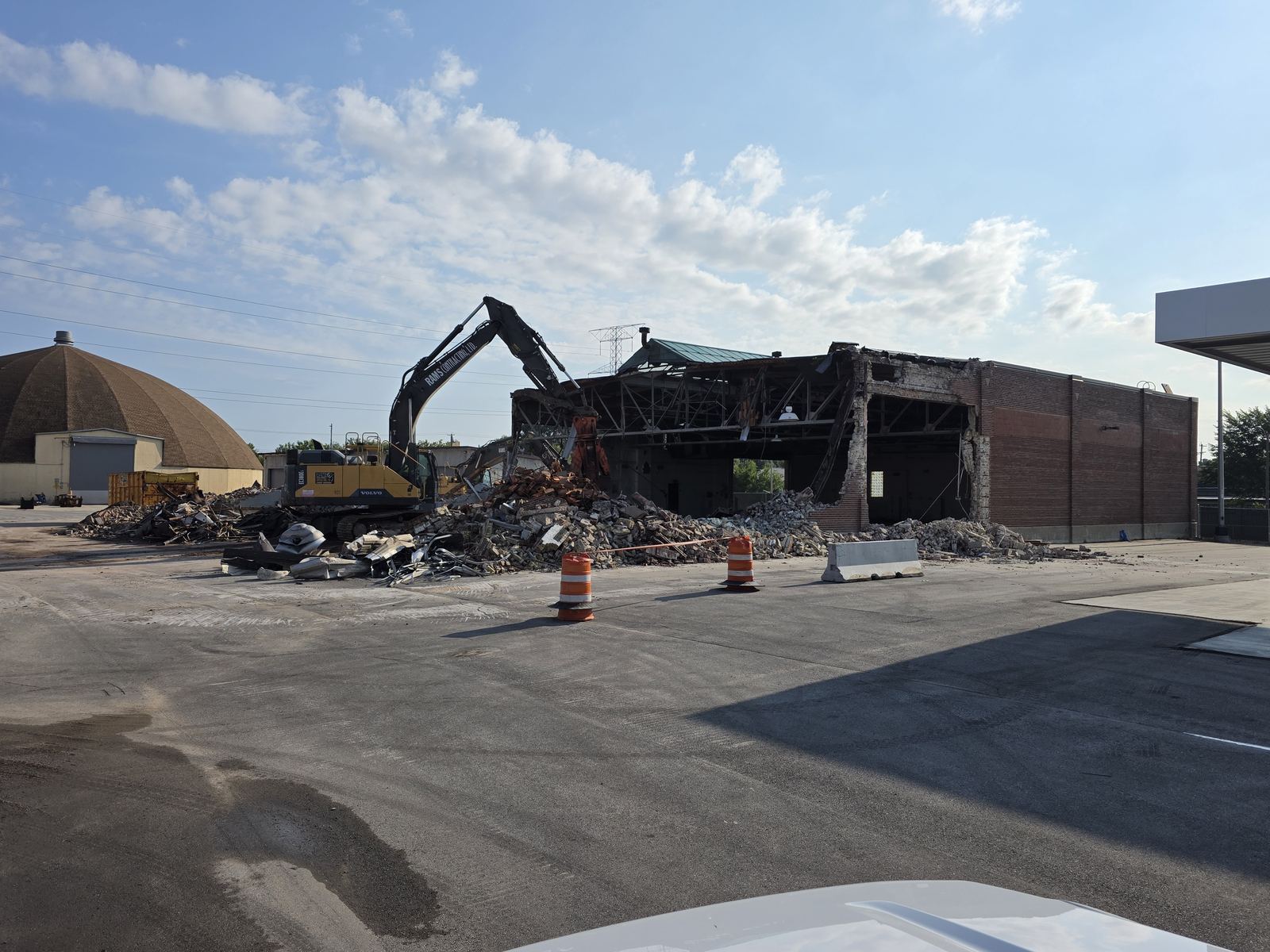 Excavators demolishing a brick school building