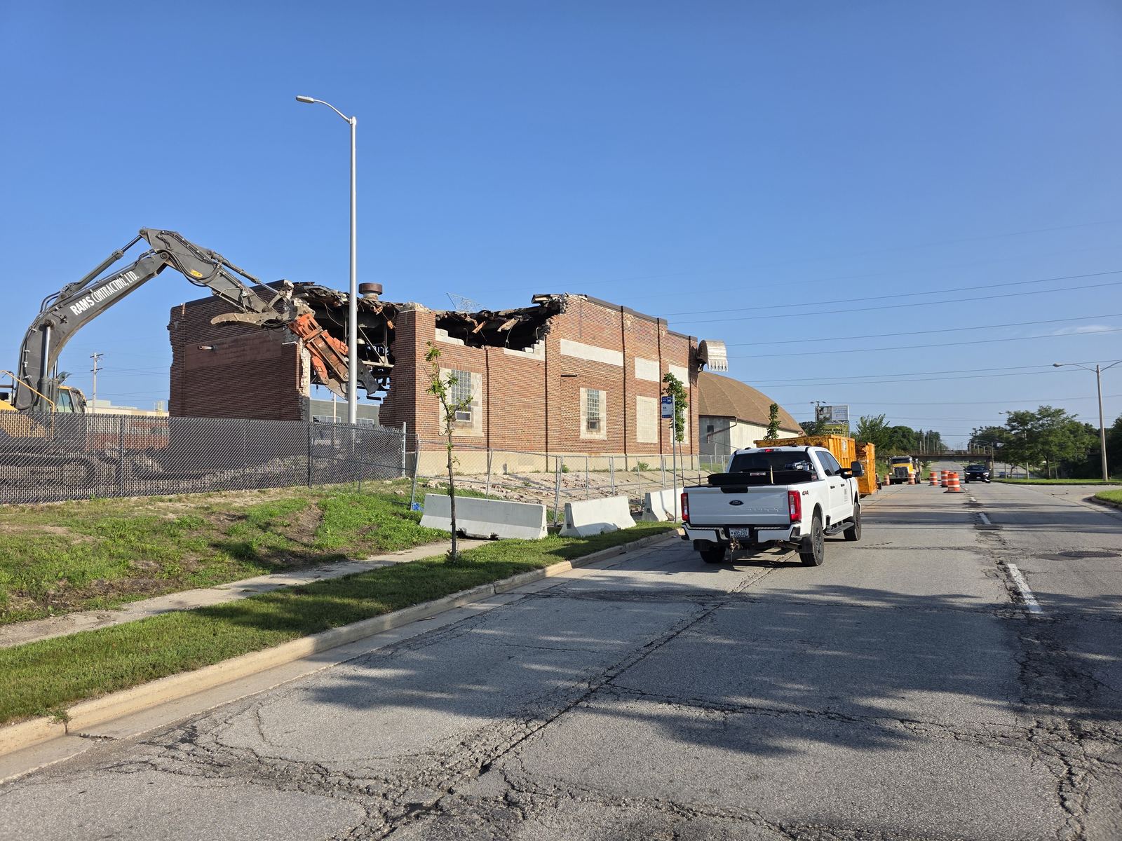 Demolition excavator working through a brick school structure