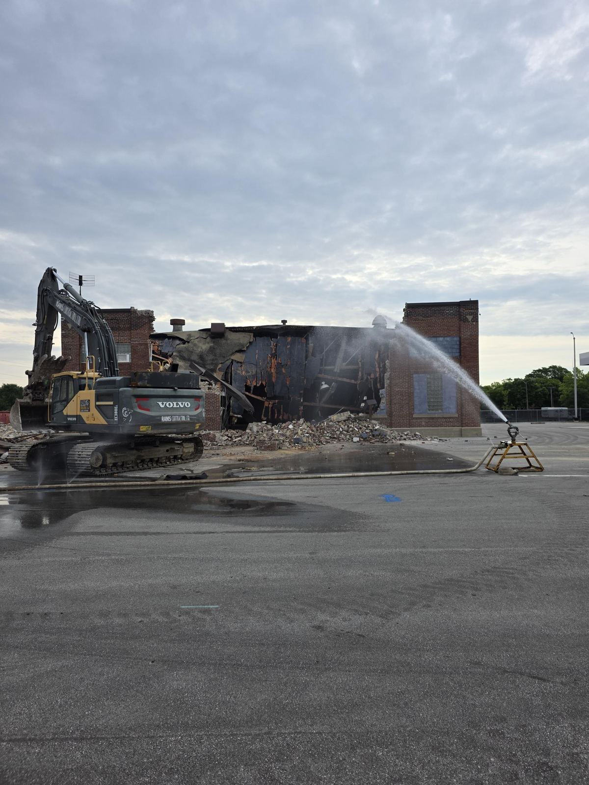 Water spray suppressing dust during a demolition site operation