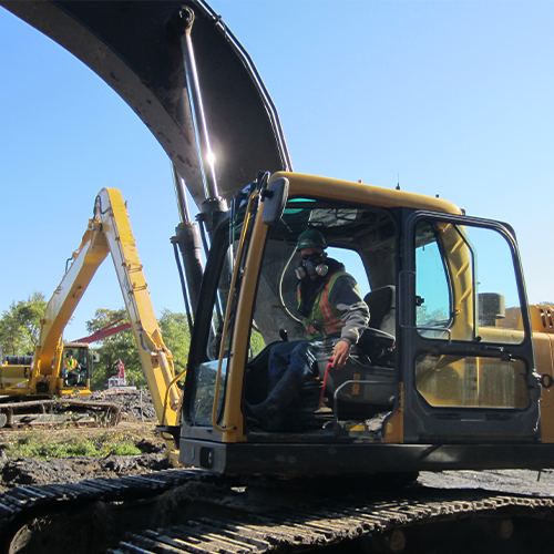 Rams equipment operator seated in an excavator cab